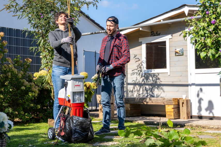 Gartenhäcksler ILH 3000 S Ein Mann und eine Frau häckseln Äste in einem Garten mit dem ILH 3000 S.